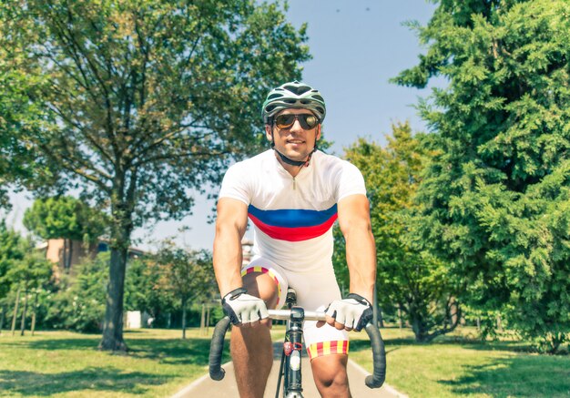 Fully equipped cyclist riding through the park