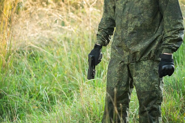 Fully equipped military men with automatic weapons getting ready to play airsoft strikeball, cropped view