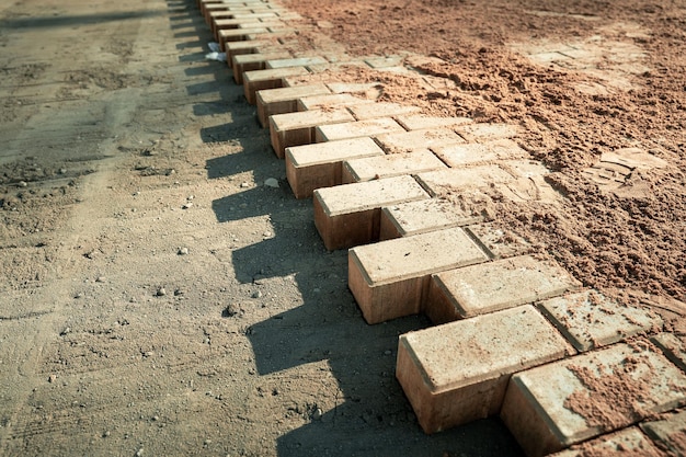 Not fully laid paving slabs on the site prepared for laying