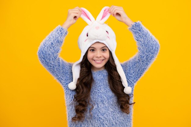 Fun bunny warm hat winter hat cold season concept winter fashion accessory for children teen girl wearing warm knitted hat happy teenager positive and smiling emotions of teen girl