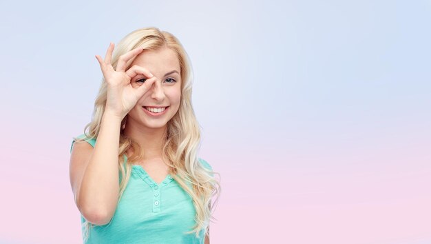 fun, emotions, expressions and people concept - smiling young woman or teenage girl making ok hand gesture over pink background