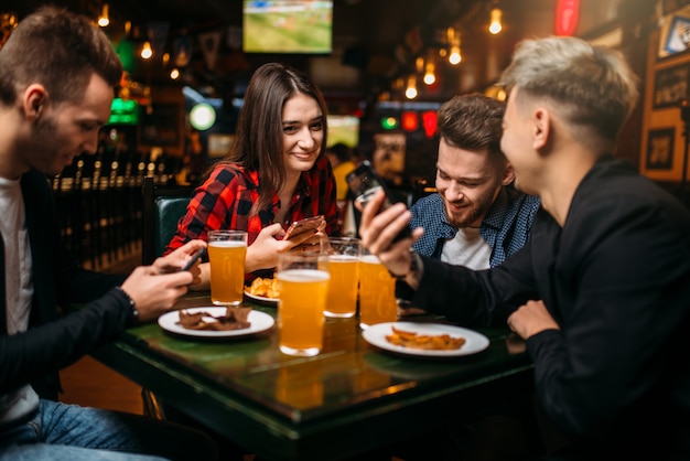 Fun friends in a sport bar, victory celebration, happy leisure of football fans