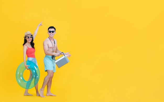 Fun happy Asian couple in casual summer beach outfits with accesseries