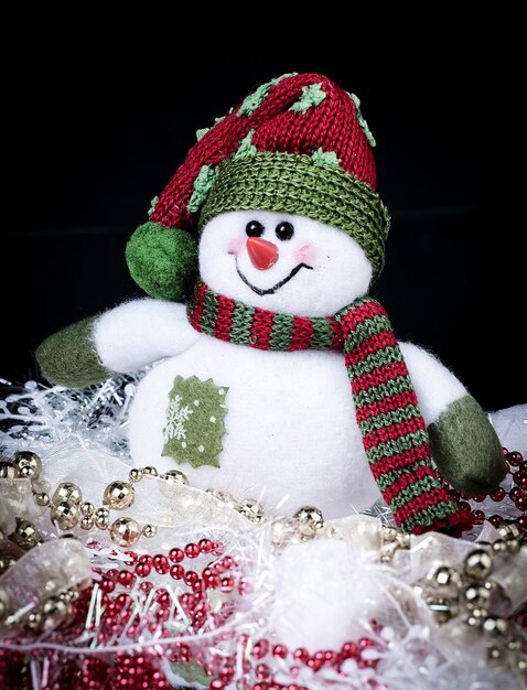 Photo fun toy snowman and christmas decorations on a black background