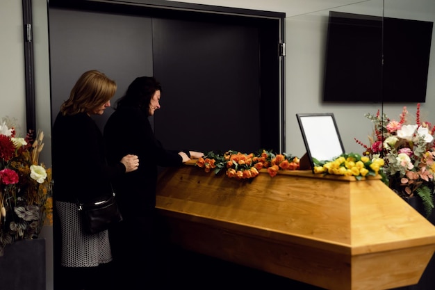 funeral ceremony a widow and family members are crying near the coffin familys longing for the