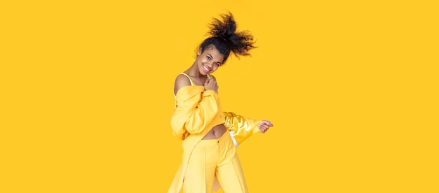 Funky african girl wear stylish yellow clothes on background banner