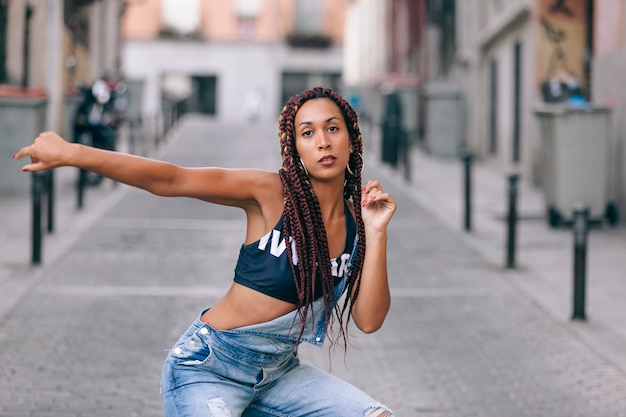 Funky black woman dancing alone in the street