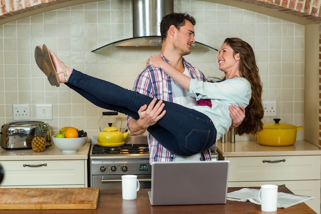 Funky couple having fun in kitchen