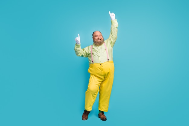 Funky overweight man dancing on blue background