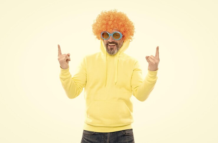 Photo funky party bearded man wear funky wig nerdy look showing sign of horns heavy metal culture