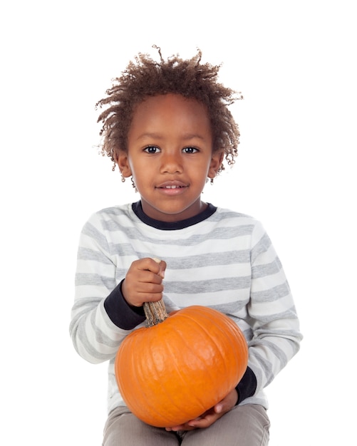 Funny African American boy with a pumpkin 