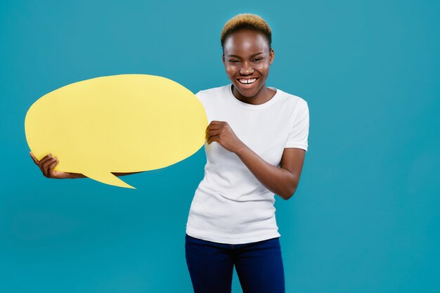 Funny african woman standing with paper speech bubble.