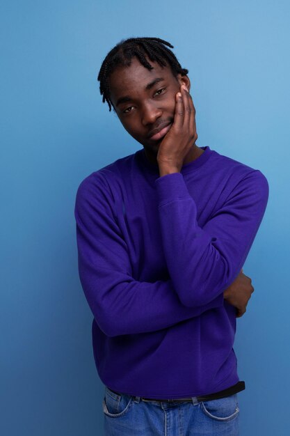 Funny american young man with dreadlocks in a blue sweatshirt