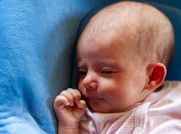 a funny baby sleeps in his crib