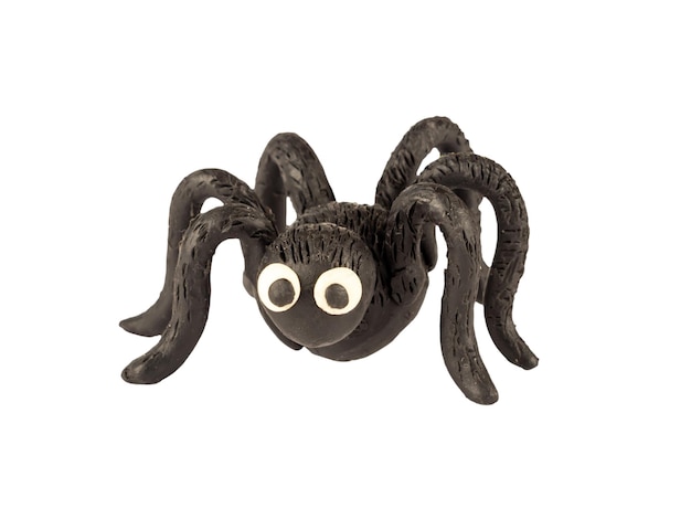 Funny black spider made of plasticine isolated on a white background