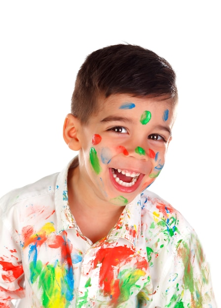 Funny boy with hands and face full of paint