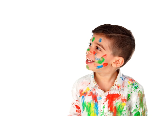 Funny boy with hands and face full of paint