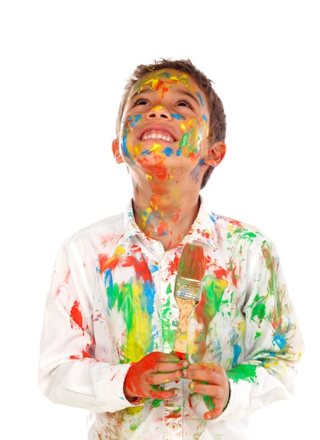 Funny boy with hands and face full of paint