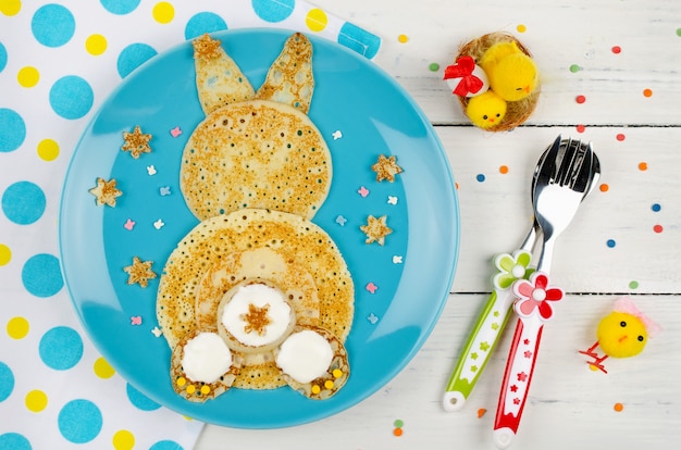 Funny bunny pancakes on the plate. Top view