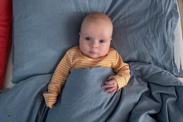 Funny caucasian baby lying on the bed