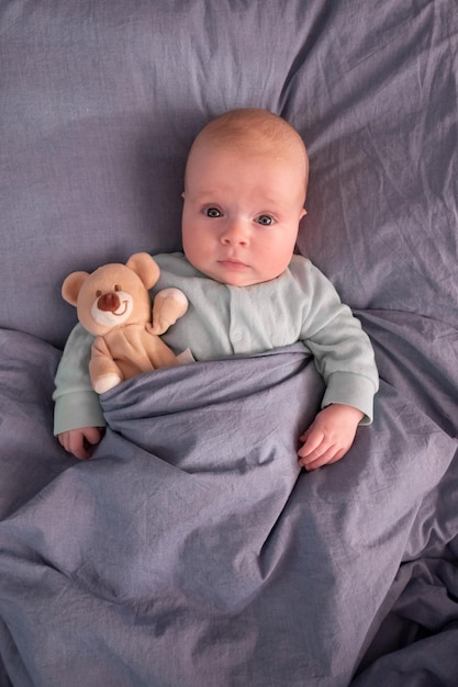 Funny caucasian baby lying on the bed