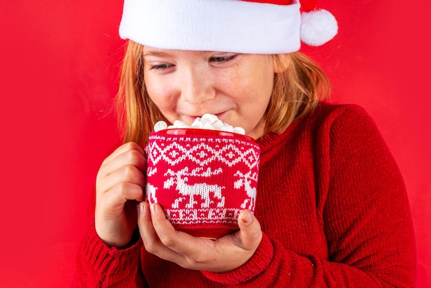 Funny caucasian girl with cup of Christmas cocoa