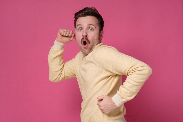 Funny caucasian young man hurrying to meet dream goal I am late concept