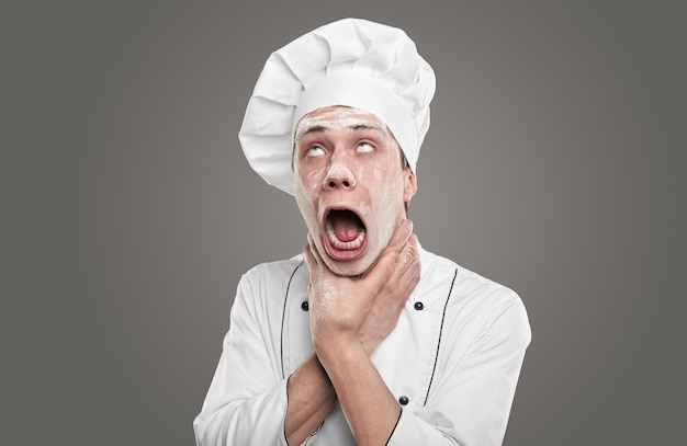 Funny chef with mouth opened and hands on neck