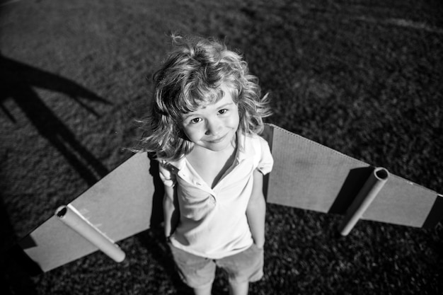 Funny child boy playing with toy jetpack child pilot astronaut or spaceman dreams of flight aviator