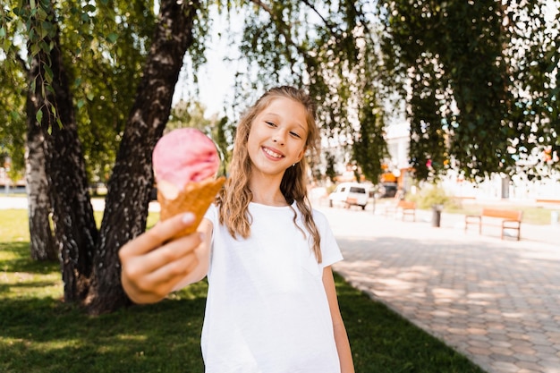 Funny child girl with ice cream cone in waffle cup Summer sweets food Creative advert for ice cream stand and shop