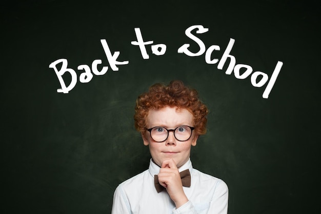 Funny child in glasses Back to school concept