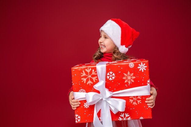 funny child holding a gift in his hands looks away to Give gifts.