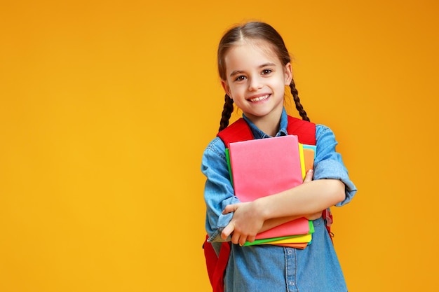 Funny child school girl girl on a yellow background