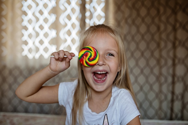 Photo funny child with candy lollipop