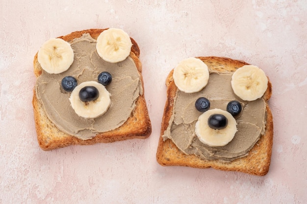 Funny children bear toasts with nuts butters for breakfast