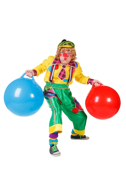 Funny clown with balls in studio isolated on white background