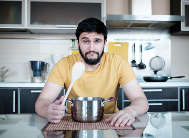 Funny cooking Attractive caucasian man in the kitchen