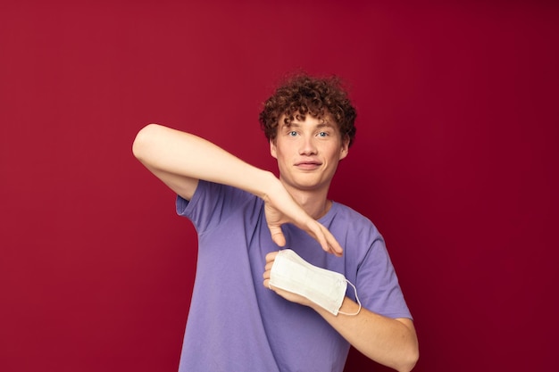 Funny curlyhaired guy in a purple tshirt gestures with his hands