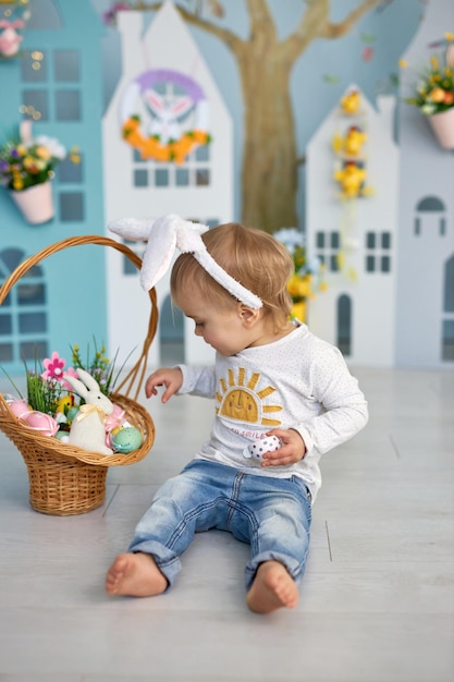 Funny cute girl in bunny ears celebrating Easter