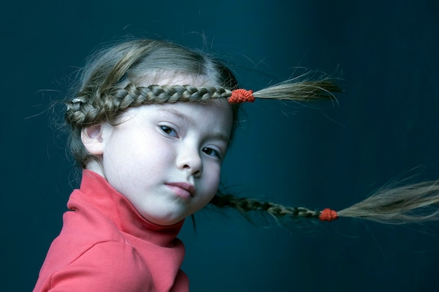 Funny cute girl with pigtails in the wind