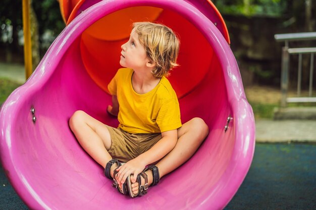 Funny cute happy baby playing on the playground The emotion of happiness fun joy