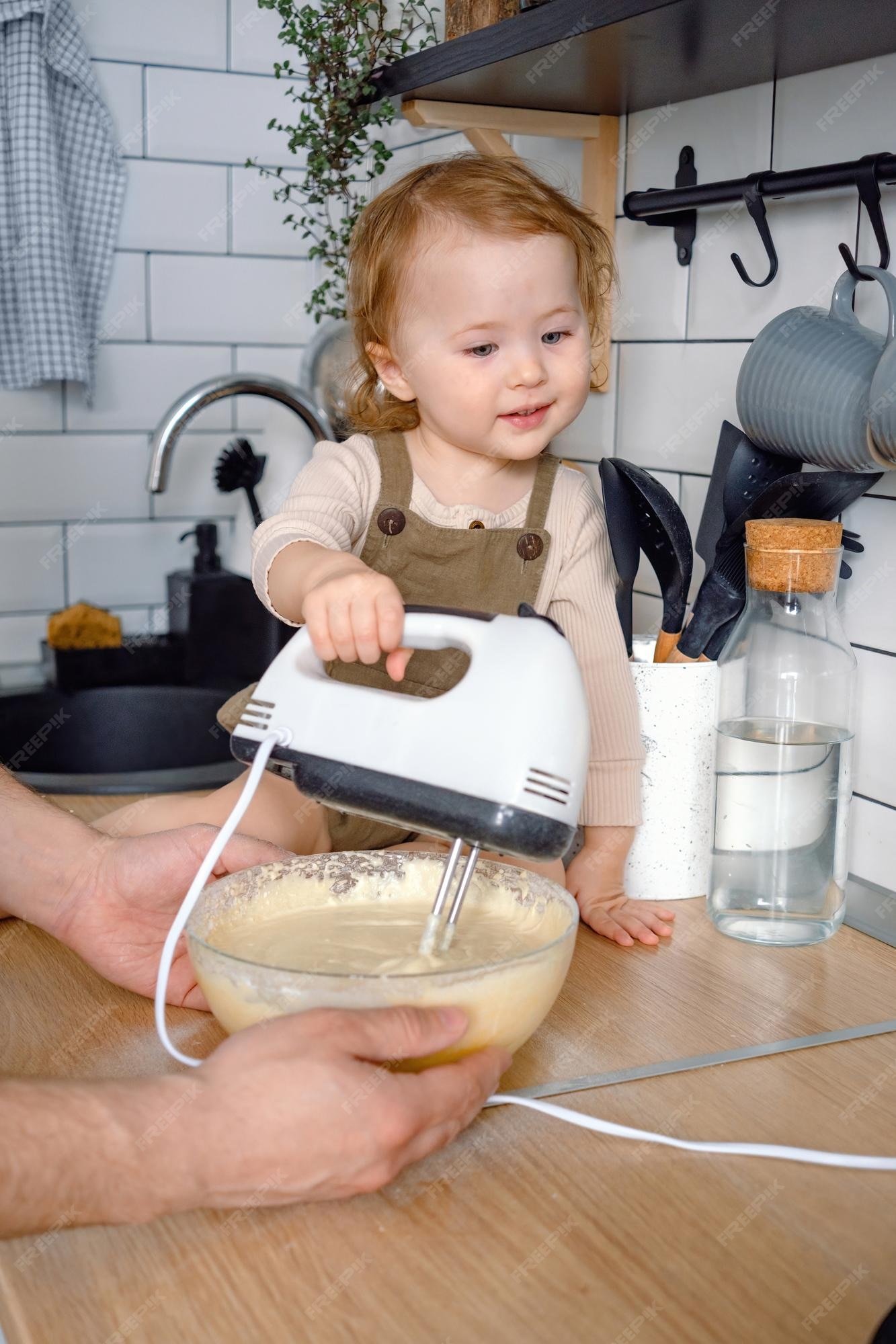 Premium Photo  A funny cute toddler mixing ingredients using blender  helping father a kid learning to cook