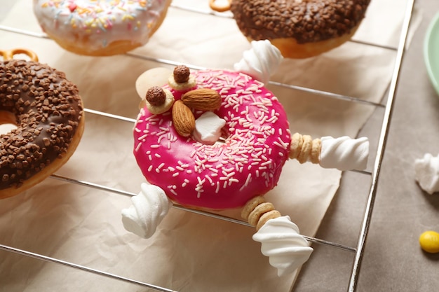 Funny decorated donut on grille