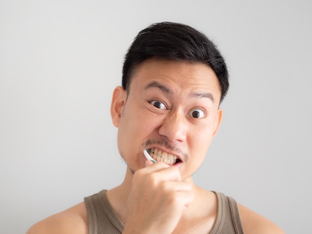 Funny face man brush his teeth without foam.