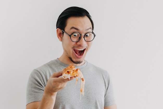 Funny face nerd man has cheesy pizza isolated on white background