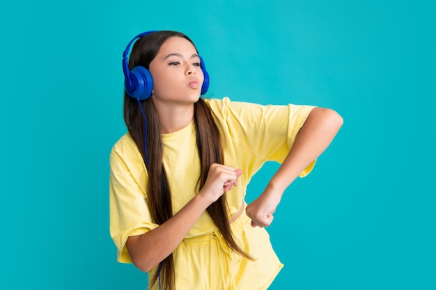 Premium Photo | Funny face teenager in modern wireless headphones enjoying  song music in audio app listening to her favorite music over blue studio  background