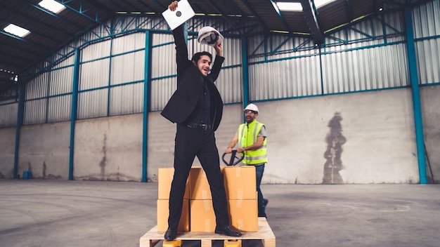 Funny factory workers dance in the factory . happy people at work .