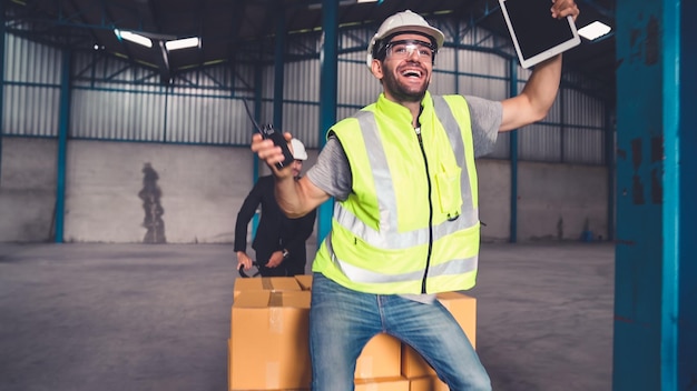 Funny factory workers dance in the factory Happy people at work