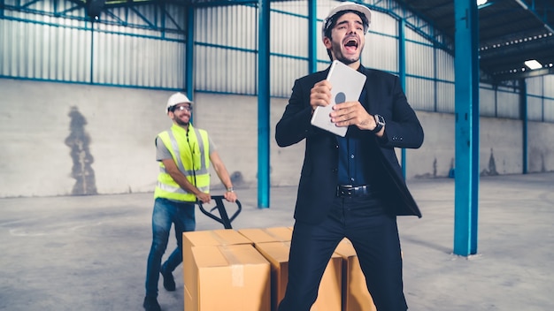 Funny factory workers dance in the factory