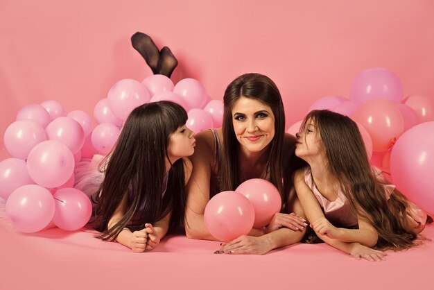 Funny family on a background of bright pink wall